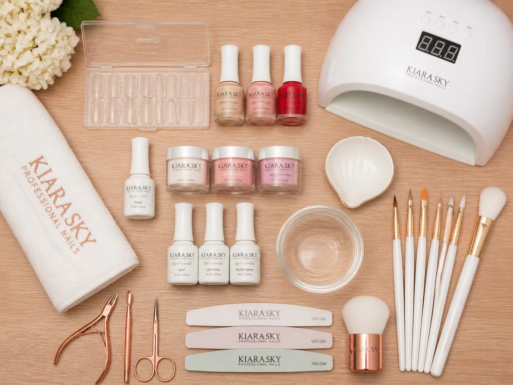 Professional nail supplies neatly arranged on a table: polish bottles, nail files, brushes and LED lamp at Saner 812 Styles in Columbus, Indiana